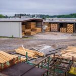 A comprehensive view of an industrial lumber yard showcasing neatly stacked wood planks ready for distribution.